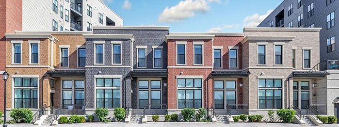 Completed townhome facades with brick detailing